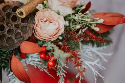 New Year's and Christmas decoration. Dried Lotus flowers, cinnamon sticks, fir branches and festive toys arrangement