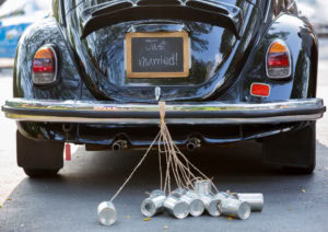 Vintage wedding car with just married sign and cans attached