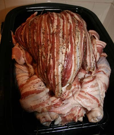 turkey wrapped in bacon in pan ready to cook