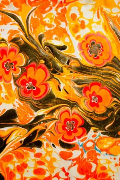 orange and yellow floral textile using an acrylic pour painting technique