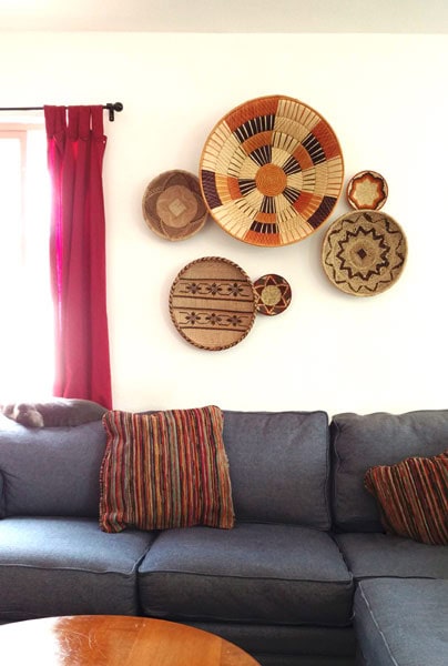 Several African baskets hanging on a wall