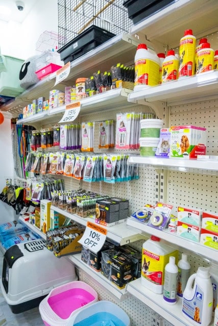 Pet supplies arranged along shelves in a store aisle