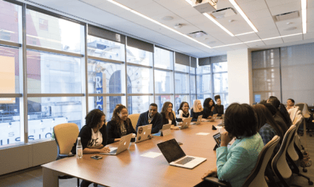 A team in an office discussing customer reference management during a meeting