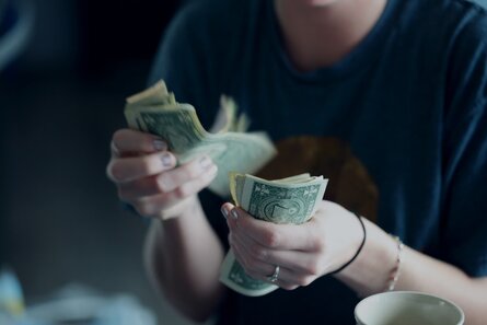 woman counting cash in hand