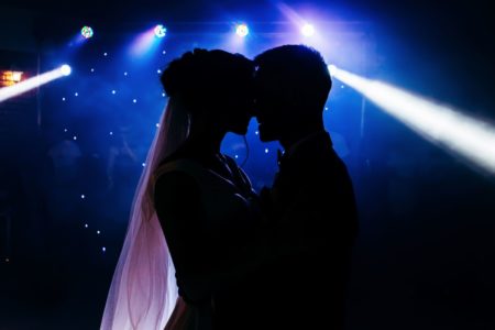 bride and groom facing each other in silhouette