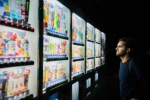 a man staring at the vending machines