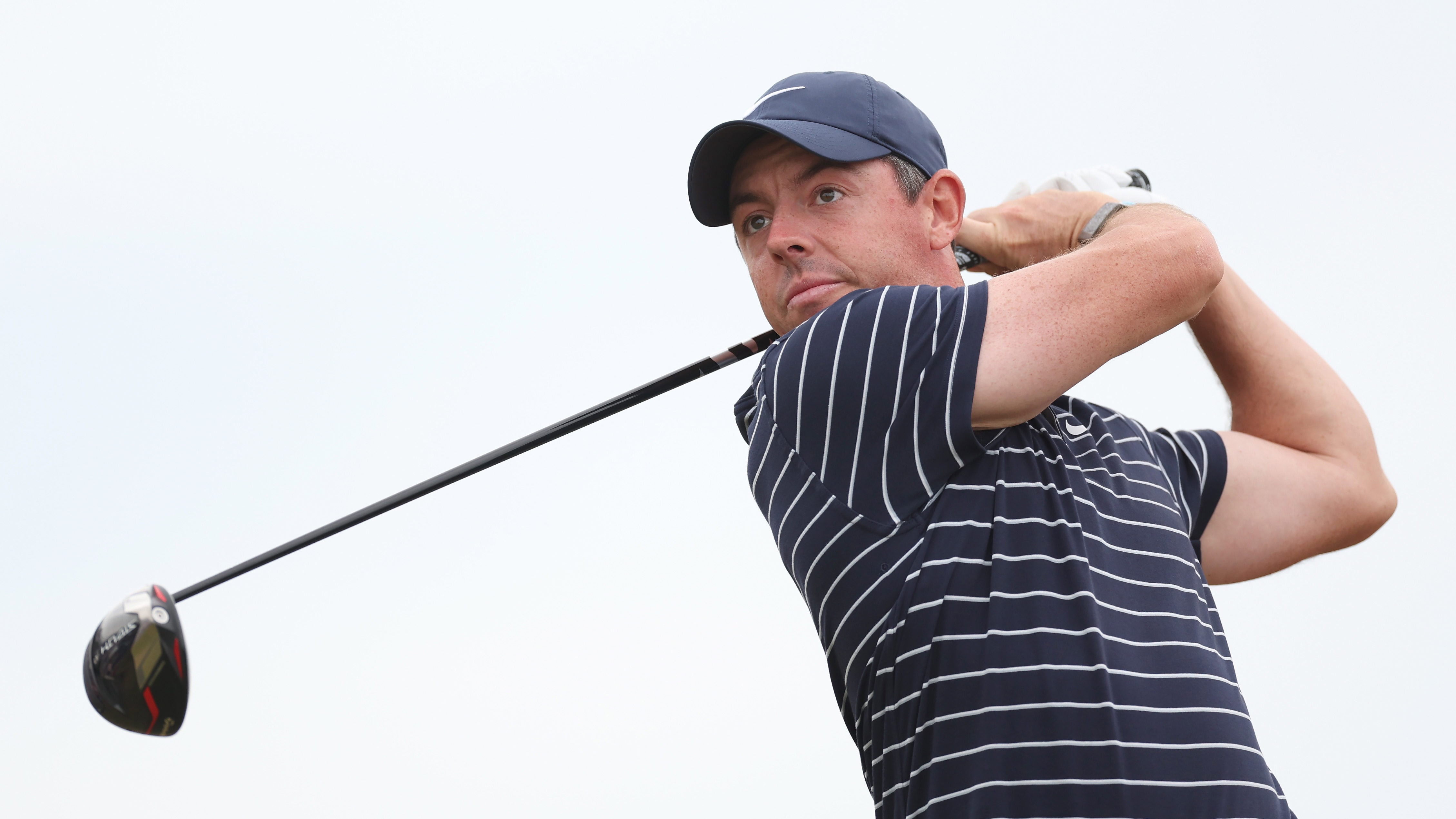 Rory McIlroy after swinging a golf club as the club sits over his right shoulder