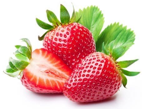 Strawberries in front of leaves on white bg