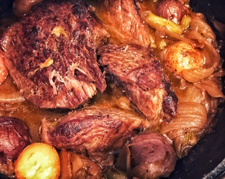Pot roast and potatoes in a pot