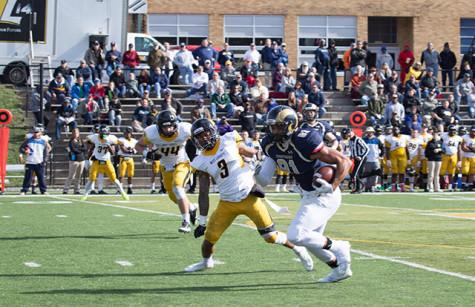 Billy Brown, #81, runs the football down the field to get a first down against West Liberty. 