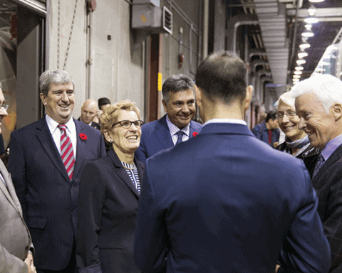 Ontario Premier Kathleen Wynne, with Transportation Minister Glen Murray (left, wearing poppy) and Finance Minister Charles Sousa (right), announce provincial green bonds program on Oct. 30.