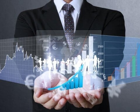 A businessman with financial symbols coming from hand