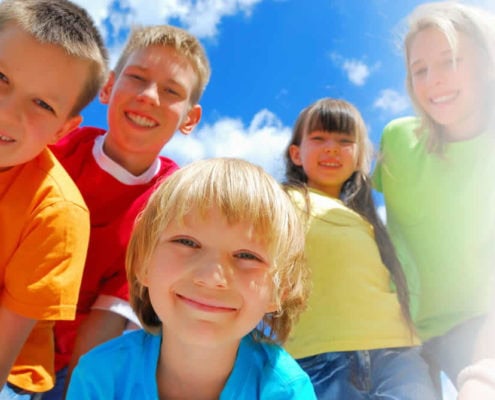 young children smiling enjoying outdoors after having natural allergy treatment