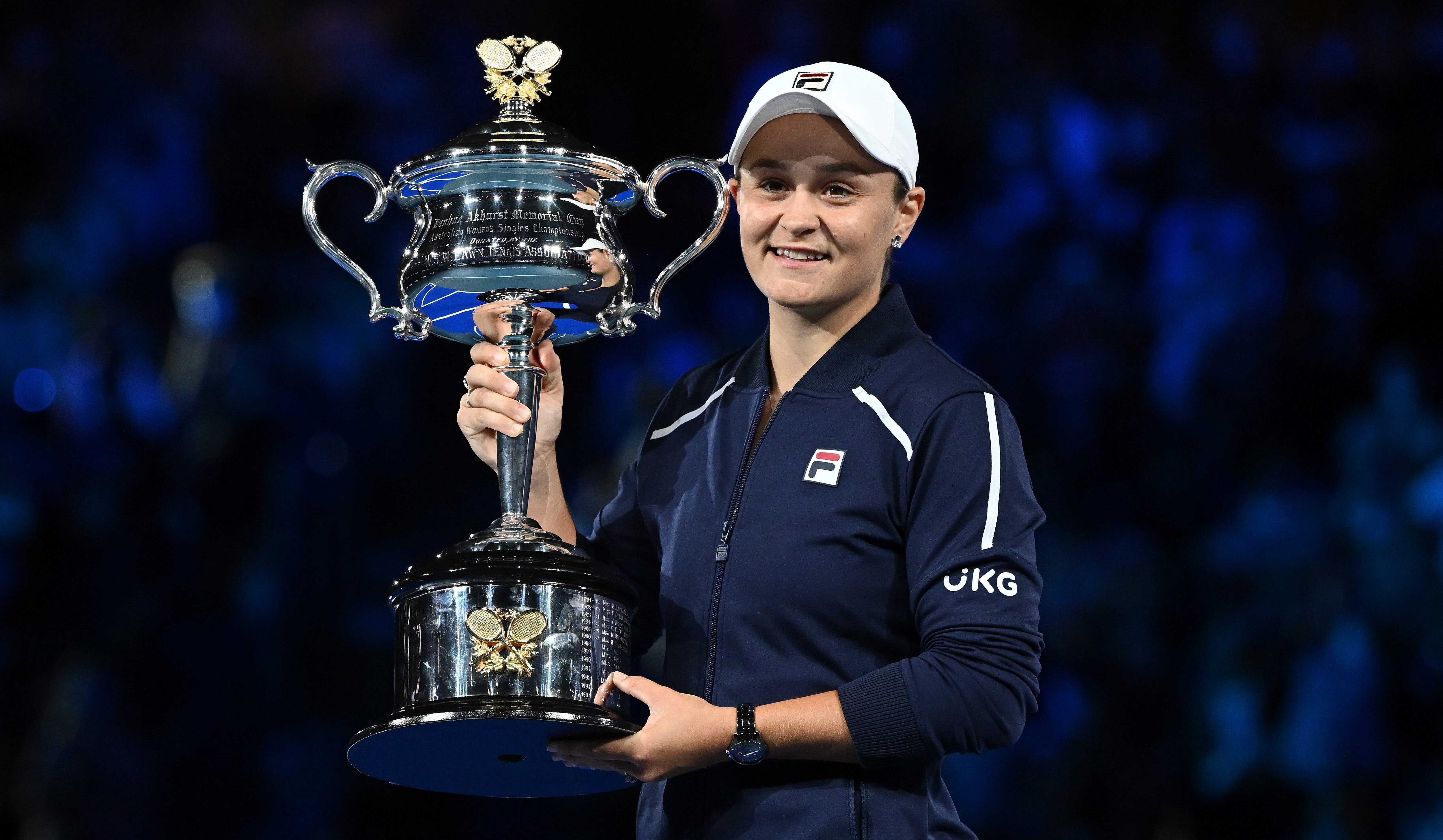 Tennis player Ash Barty holding the at the crowd after winning the 2022 Australian Open trophy at Rod Laver Arena