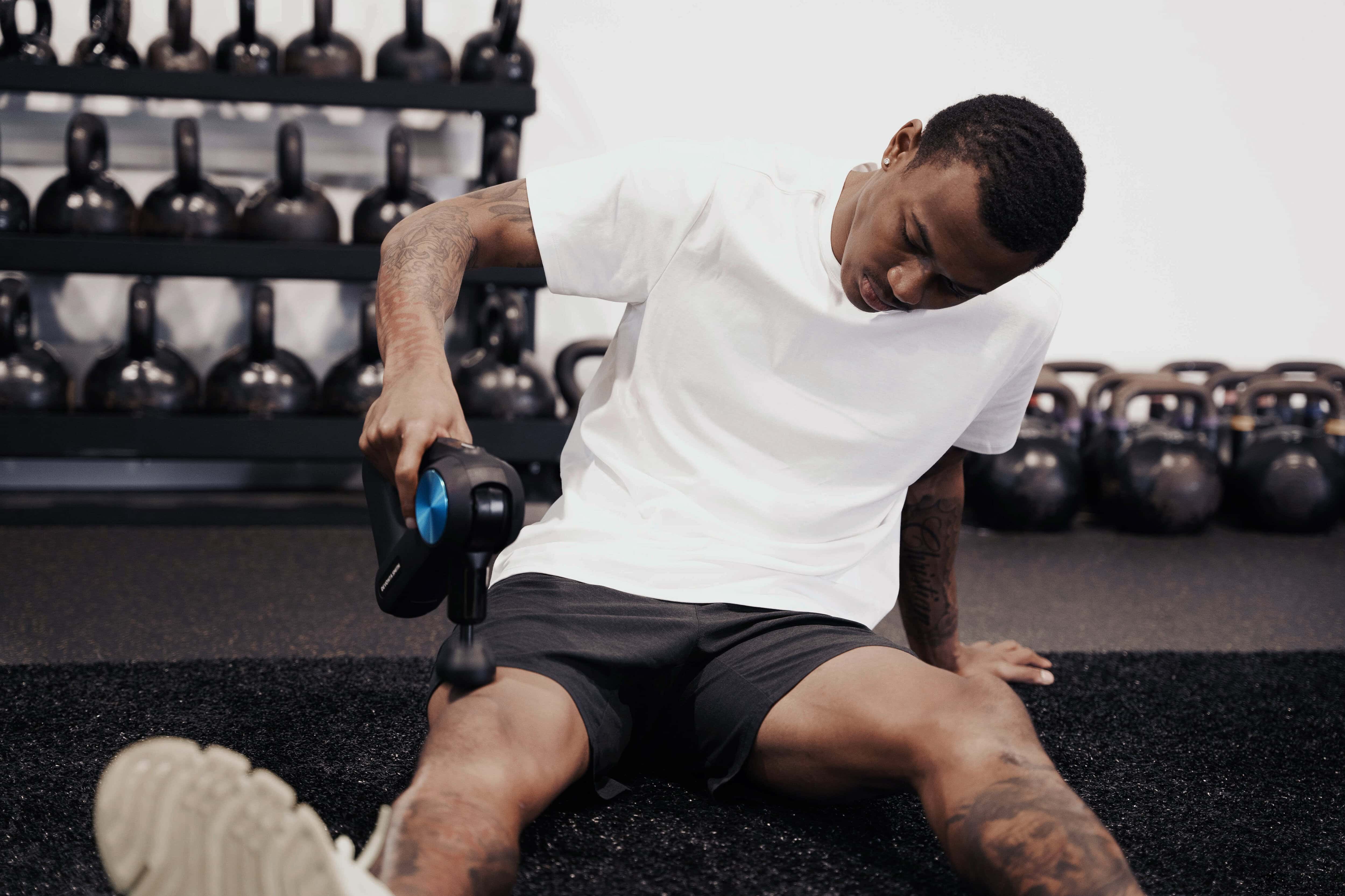 Heisman Trophy winner Devonta Smith with a Therabody therapy gun