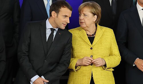 BRUSSELS, BELGIUM - DECEMBER 14:  President of France Emmanuel Macron, and Chancellor of Germany Angela Merkel speak during the launch of the Permanent Structured Cooperation,  (PESCO), a pact between 25 EU governments to fund, develop and deploy armed forces together, at the European Council on December 14, 2017 in Brussels, Belgium. The European Council summit is meeting for two days to discuss issues related to Brexit, defence, education, immigration and foreign policy.  (Photo by Dan Kitwood/Getty Images)