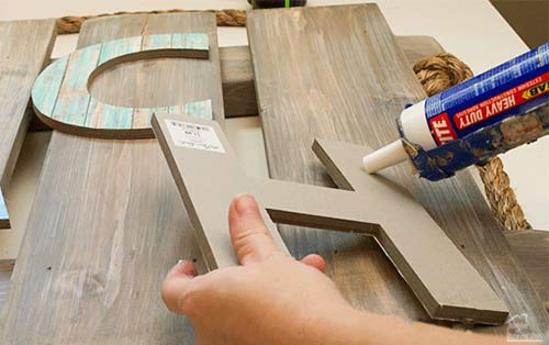 glueing letters to wood pallet display