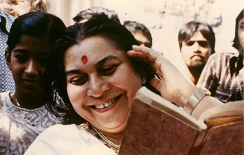 SK_shri-mataji-smiling-while-reading-a-book-in-india
