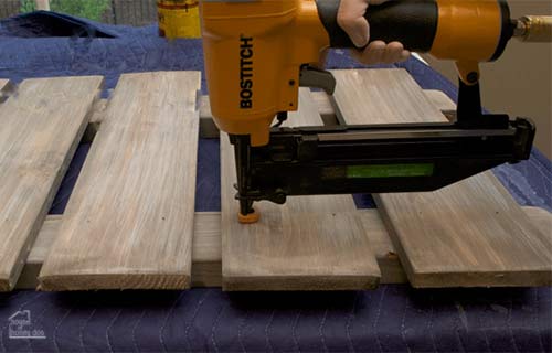 using nailgun to attach pallet boards 