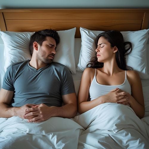 Frequent Urination Affecting Intimacy — And How My Sister Saved Our Relationship 5 Couple in bed with emotional distance caused by erectile dysfunction due to stress.