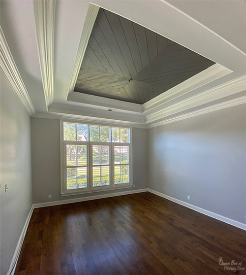 room with chevron plank ceiling