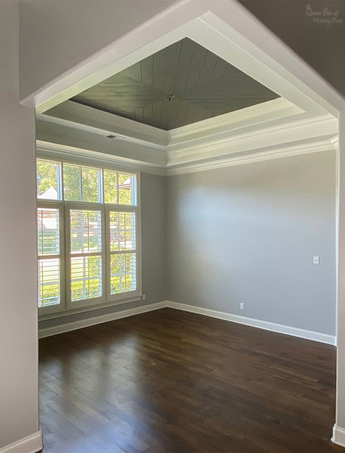 room with chevron plank ceiling