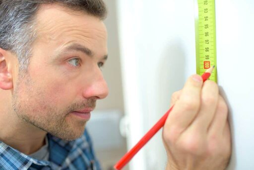 carpenter using a tape measure