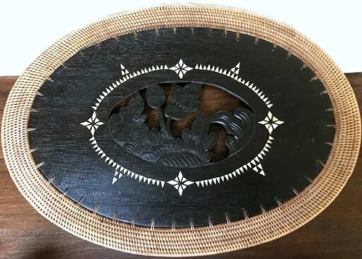 Rattan placemat with animals carved in center