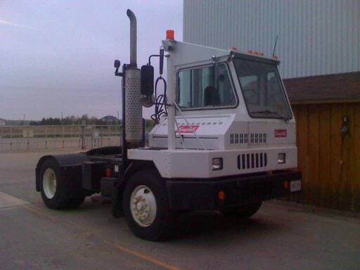 A terminal tractor at a warehouse yard.