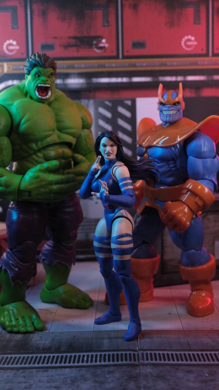 Marvel Legends action figures of Hulk, Psylocke, and Thanos posed together in a futuristic diorama scene