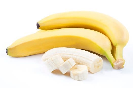 2 whole bananas and one peeled and diced on white bg