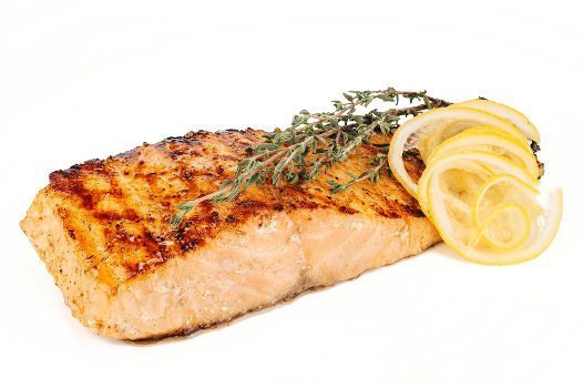 Grilled fish with lemon slices on white bg