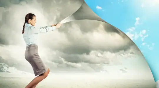 A woman pulling open a wall of gray clouds to show a background of blue skys