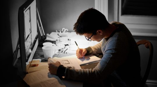 Student doing homework at their desk at night