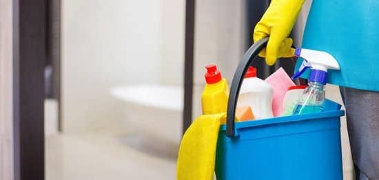 hand holding bucket of cleaning supplies to make home look better