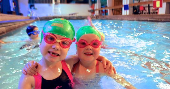 two children with swimming goggles at Blue Wave Swim school's swim lessons