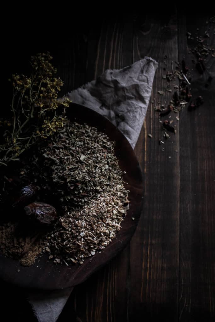 whole nutmeg, dried lemon balm, coriander and other spices used to make Carmelite water (lemon balm wine)