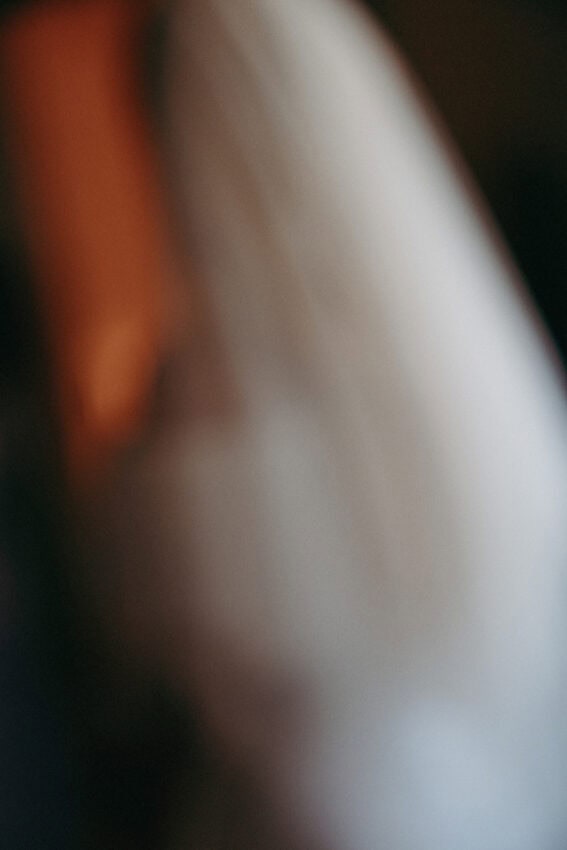 A soft, abstract image with blurred white and brownish areas, creating an indistinct and dreamy visual effect. No clear shapes or objects are discernible.