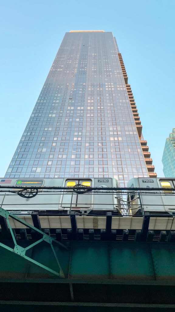 Photo of overground train and skyscraper in Queens NYC