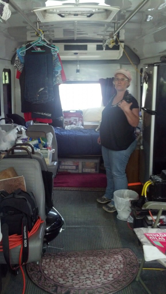 This is their overall space, bed to the back, tables on the left, kitchen to the right