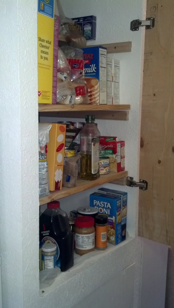 And used some scrap pieces of wood I had sitting around from another project to make shelves, I can fit a heck of a lot of food in there!  I actually designed them around the mason jars so that when I get into canning there is no problems storing my goods! 