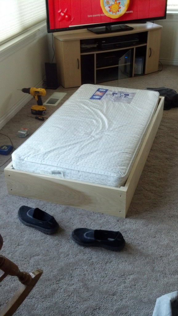 The base of the co-sleeper is in, the mattress is elevated.