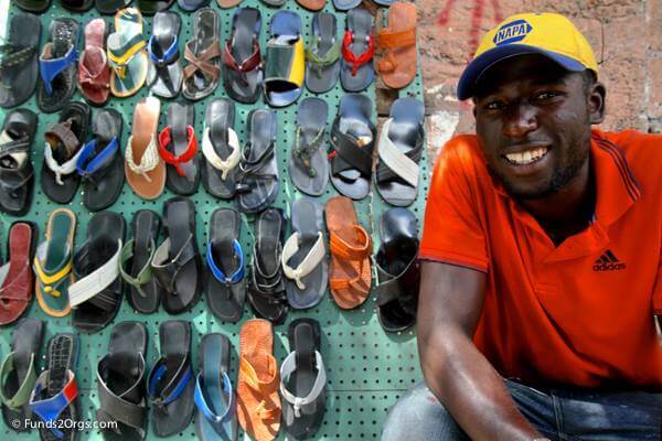 A Haitian man busy selling his wares on the street.