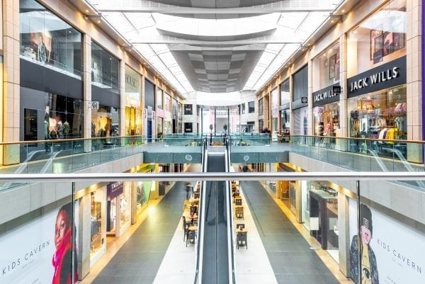 Metquarter shopping Centre interior image showing the lower and upper tiers of the mall with an escalator in the middle