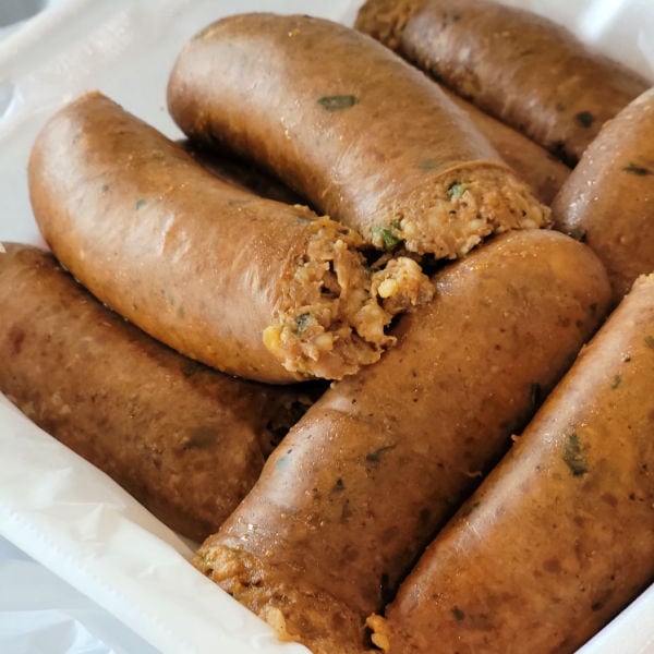 Boudin links sit in styrofoam container