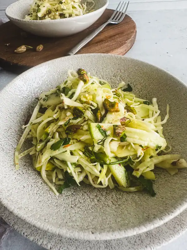 Cabbage and Apple Slaw with Fennel and Pistachios in a bowl