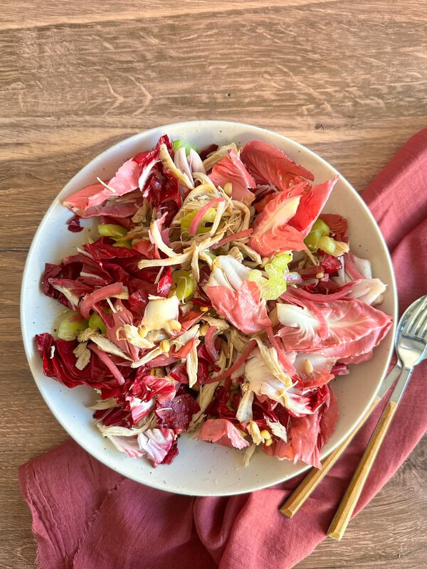 Italian Chicken Salad with radicchio on a wooden table
