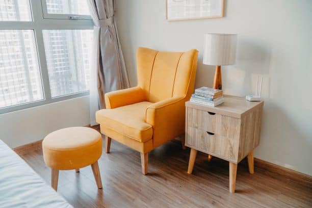 Orange chair and ottoman with side table, mid-century modern