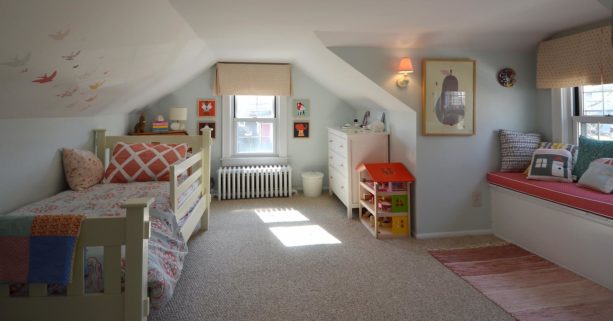 simple girl’s bedroom in the attic with low and slanted walls