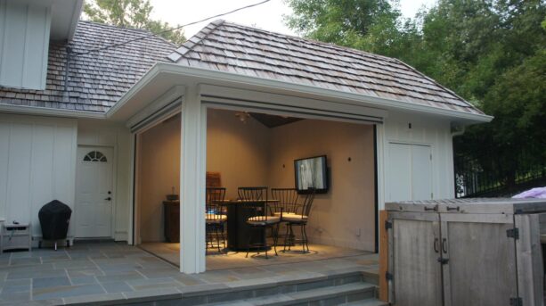 a small yet elegant traditional back porch is attached to the house